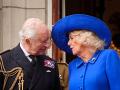 Britain's King Charles III and Britain's Queen Camilla speak, on the balcony of Buckingham Palace after attending the armed forces procession on May 5, 2025 to celebrate the 80th anniversary of VE Day also known as Victory in Europe Day, marking the end of the Second World War in Europe. (Photo by Aaron Chown / POOL / AFP)