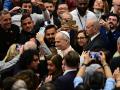 Pope Leo XIV (C) meets with journalists using smartphones during an audience to representatives of the media, at Paul-VI hall in The Vatican, on May 12, 2025. (Photo by Tiziana FABI / AFP)