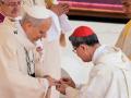 Filipino cardinal Luis Antonio Gokim Tagle puts the Fisherman's Ring on a finger of Pope Leo XIV during a mass for the beginning of his pontificate, in St Peter's square in The Vatican on May 18, 2025.  (Photo by Jacquelyn Martin / POOL / AFP)