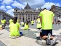 People pray as Pope Leo XIV addresses the crowd from the window of the Apostolic Palace overlooking St. Peter's square during his Angelus prayer at the Vatican on July 26, 2025. (Photo by Alberto PIZZOLI / AFP)