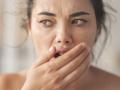 Woman is checking smell of breath