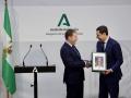 El hermano mayor de la Esperanza de Málaga hace entrega de una imagen de la Virgen al presidente de la Junta, Juanma Moreno