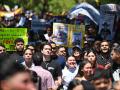 University students, opponents of the government, and relatives of political prisoners, take part in a march on the Youth Day in Caracas on February 12, 2026. The first major opposition demonstration after the fall of Nicolas Maduro during a US military incursion a month ago gathered thousands of people in Venezuelas capital on February 12, ahead of the approval of a historic amnesty law. (Photo by Juan BARRETO / AFP)