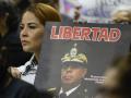 A relative of a political prisoner holds a banner during a press conference in Caracas on February 23, 2026. More than 200 Venezuelan political prisoners were on hunger strike on February 22, 2026, to demand their release under a new amnesty law that excludes many of them. (Photo by Pedro MATTEY / AFP)