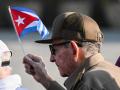 Cuba's former President Raul Castro holds a Cuban national flag as he attends a May Day rally marking International Workers Day in Havana on May 1, 2026. (Photo by YAMIL LAGE / AFP)