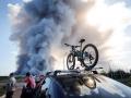 Bystanders watch as smoke rises from a fire at the Russian e-commerce firm Wildberries' logistics complexes in the town of Elektrostal outside Moscow on July 18, 2026. A Ukrainian drone attack on two logistics centres in Russia killed eight people and injured 24, officials said on July 18, 2026, when the Moscow region reported a new wave of drone strikes. Russian e-commerce firm Wildberries said its logistics complexes in Kotovsk and Elektrostal, in the Tambov and Moscow regions respectively, came under attack. One person was killed and 37 were injured at the Elektrostal warehouse, according to the region's governor, Andrei Vorobyov. (Photo by TATYANA MAKEYEVA / AFP)