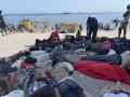 CEUTA, 09/08/2026.- Numerosos inmigrantes permanecen en la playa del Trampolín que se ha transformado en un asentamiento desde la entrada masiva registrada a finales de julio en la ciudad Ceuta.  EFE/Reduan