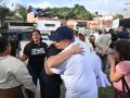 Venezuelan activist Andreina Baduel embraces a released political prisoner outside El Rodeo I prison in Guatire, Miranda state, Venezuela, on August 14, 2026. Venezuela released 131 political prisoners on August 14, including a woman accused of involvement in an alleged drone attack against ousted leader Nicolas Maduro, following Un preso político venezolano siendo recibido por su familia tras haber sido liberado