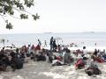 Varios migrantes en la playa, a 1 de agosto de 2026, en Ceuta (España).