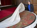 Chairman of the Metz Cathedral Trust Philippe Hiegel unveils the cope of Charlemagne, a liturgical cope made of red silk woven with gold and silver, and the coronation cloak of Emperor Frederick II of Hohenstaufen, in the crypt of Saint-Etienne Cathedral in Metz, eastern France, on September 3, 2026. Leo XIV's stop in Metz on September 28 will mark the first papal visit to the city since Pope John Paul II in 1988, and will close out his four-day apostolic journey to France that also esi:includes Paris and Lourdes. (Photo by Jean-Christophe VERHAEGEN / AFP)