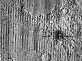 This handout picture, made out of stacking hundreds of images over several years, and published on September 16, 2026 by NASA, shows a zoomed-in view of the Moon, with debris around a new crater visible as a white spot circled by a dark halo just right of center of the image, marked with black arrows, taken by the Lunar Reconnaissance Orbiter Camera. US researcher Robert Wagner with NASA's Lunar Reconnaissance Orbiter (LRO) has discovered a massive crater that recently formed on the surface of the Moon, thanks to images from a NASA probe, an "event that only happens once a century", according to scientists. Named "McGetchin", the 222-meter-wide (aprox. 728 feet) crater is thought to have been caused by the impact, in the spring of 2024, of a comet or asteroid on the lunar surface, NASA explains. (Photo by Handout / NASA / AFP) / RESTRICTED TO EDITORIAL USE - MANDATORY CREDIT "AFP PHOTO / NASA" - HANDOUT - NO MARKETING NO ADVERTISING CAMPAIGNS - DISTRIBUTED AS A SERVICE TO CLIENTS