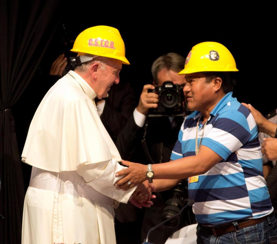 Pope Francis shakes hands with a mining worker's leader, as Bolivia's President Evo Morales during the second World Meeting of Popular Movements in Santa Cruz, Bolivia, Thursday, July 9, 2015.