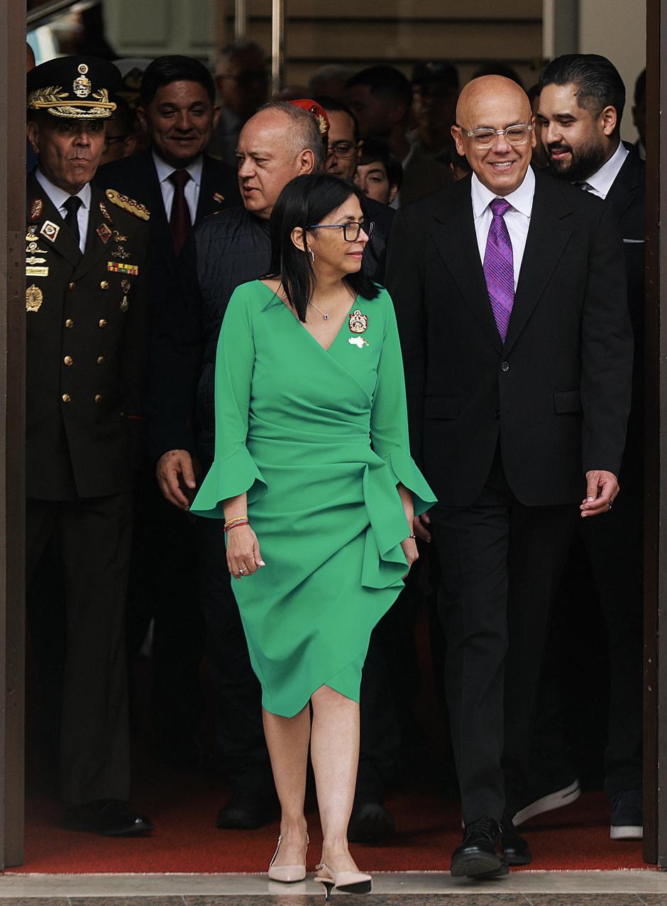 This handout picture released by the Miraflores Palace press office shows Venezuela's interim President Delcy Rodriguez (C); Venezuela's defense minister, Vladimir Padrino Lopez (L); Venezuela's minister of interior, Diosdado Cabello (Back); and Venezuela's National Assembly president, Jorge Rodriguez (R), walking after she took an oath in a ceremony at the National Assembly in Caracas on January 5, 2026. Venezuela's parliament swore in Delcy Rodriguez as interim president on January 5, two days after US forces seized her predecessor Nicolas Maduro to face trial in New York. Members of the new National Assembly offered their full backing to Rodriguez -- who had been Maduro's vice president -- and reelected her brother Jorge Rodriguez as parliament head. (Photo by Marcelo Garcia / Miraflores press office / AFP) / RESTRICTED TO EDITORIAL USE - MANDATORY CREDIT "AFP PHOTO /  MIRAFLORES PALACE PRESS OFFICE / MARCELO GARCIA" - HANDOUT - NO MARKETING NO ADVERTISING CAMPAIGNS - DISTRIBUTED AS A SERVICE TO CLIENTS
