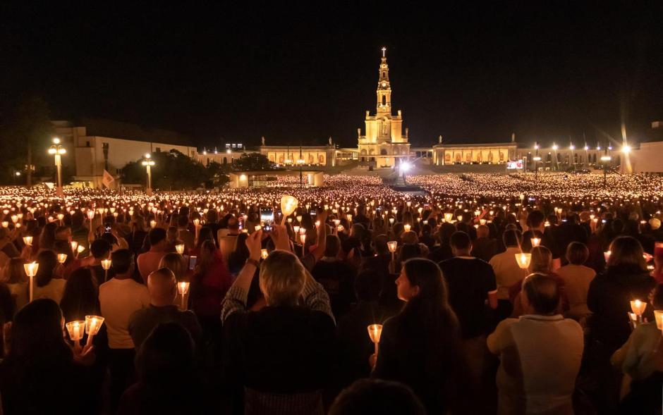 Fatima, Portugal - May 12, 2019: Shrine of Fatima in Portugal, procession of the candles with the Basilica of Our Lady of the Rosary of Fatima in the background.