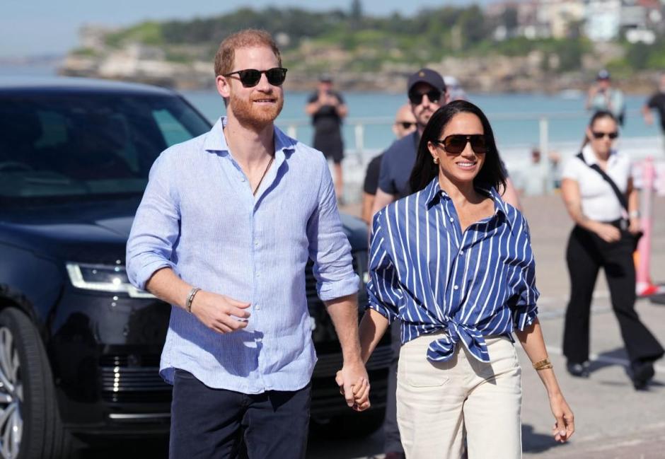 Britain's Prince Harry, Duke of Sussex, and his wife Meghan, the Duchess of Sussex, arrive to meet with volunteer first responders from Bondi Surf Bathers' Life Saving Club at Bondi Beach in Sydney on April 17, 2026. (Photo by Jonathan Brady / POOL / AFP)