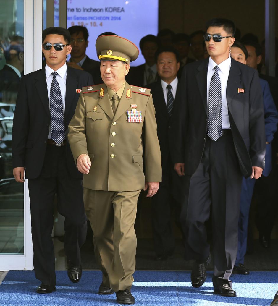 Hwang Pyong So, center left, vice chairman of North Korea¿s National Defense Commission, and Choe Ryong Hae, center right, a secretary of North Korea¿s ruling Workers Party, arrive at the Incheon International Airport in Incheon, South Korea, Saturday, Oct. 4, 2014.