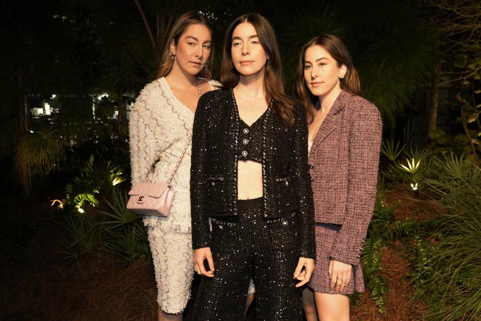 Este, left, Danielle, center, and Alana Haim, right, arrive for an event celebrating 100 years of the fragrance Chanel No. 5 during Miami Art Week, Friday, Dec. 3, 2021, in the Design District neighborhood of Miami. Artist Es Devlin was commissioned by Chanel to create an installation titled "Five Echoes" for the celebration. Miami Art Week is an annual event centered around the Art Basel Miami Beach fair.