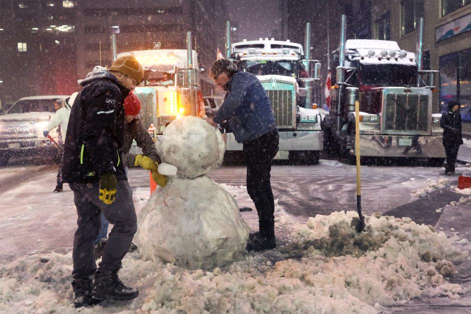 Manifestantes contra las medidas anticovid hacen un muñeco de nieve, anoche, en Ottawa