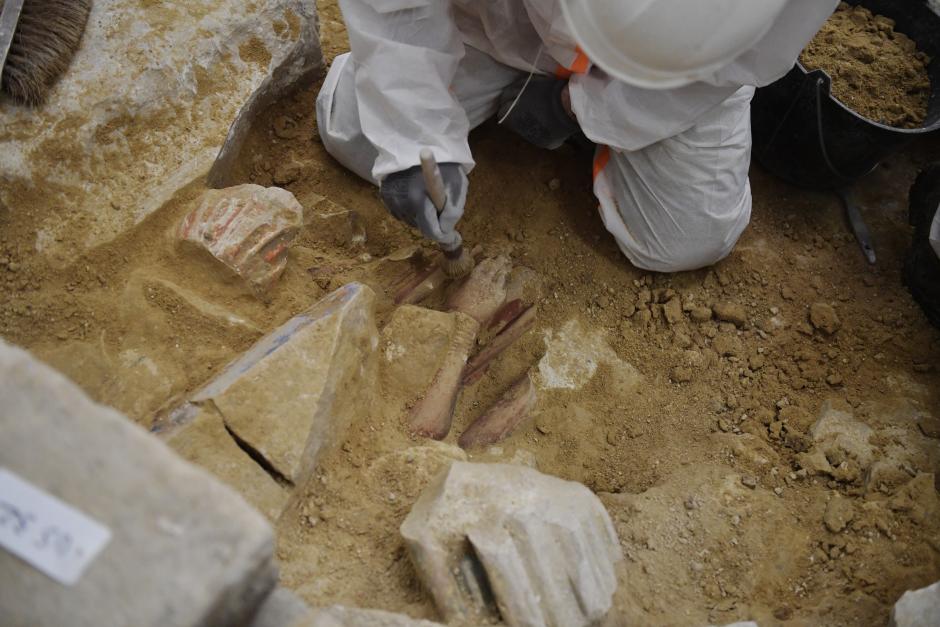 Archaeologists find antique objects in the floor of Notre Dame Cathedral after the discovery of a 14th century lead sarcophagus, in Paris, on March 15, 2022. (Photo by JULIEN DE ROSA / AFP)