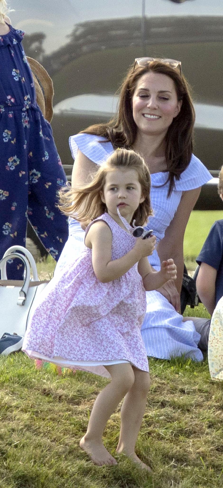 The Duchess of Cambridge and her daughter Princess Charlotte, as the Duke of Cambridge takes part in the Maserati Royal Charity Polo Trophy at the Beaufort Polo Club, Downfarm House, Westonbirt, Tetbury.