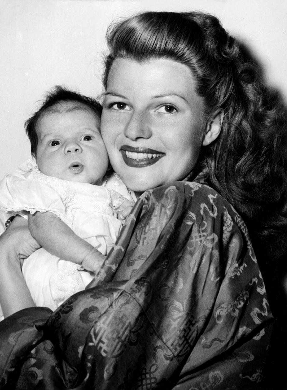 REBECCA WELLES, less than a month old, is held by her proud mother, RITA HAYWORTH, 1/18/45 
1940s candid Baby Candid Daughter Hayworth,rita Holding Mother Parent Robe Smile Welles,orson Welles,rebecca