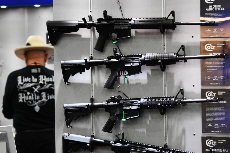 Colt M4 Carbine and AR-15 style rifles are displayed during the National Rifle Association (NRA) Annual Meeting at the George R. Brown Convention Center, in Houston, Texas on May 28, 2022. - America's powerful National Rifle Association kicked off a major convention in Houston Friday, days after the horrific massacre of children at a Texas elementary school, but a string of high-profile no-shows underscored deep unease at the timing of the gun lobby event. (Photo by Patrick T. FALLON / AFP)