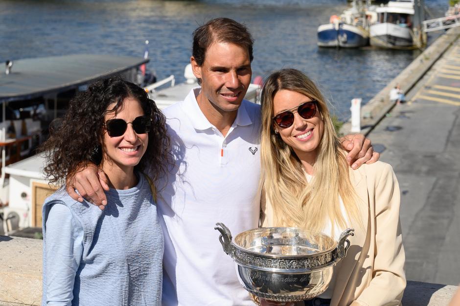 Rafael Nadal , Xisca Perello with Maria Isabel Nadal with the Musketeers Cup during a photoshoot for his 14th victory at Roland Garros on June 6, 2022 at Alexandre III bridge in Paris, France.