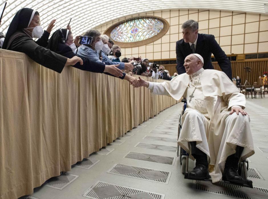 Pope Francis arrives in a wheelchair to attend an audience with nuns and religious superiors in the Paul VI Hall at The Vatican, Thursday, May 5, 2022.