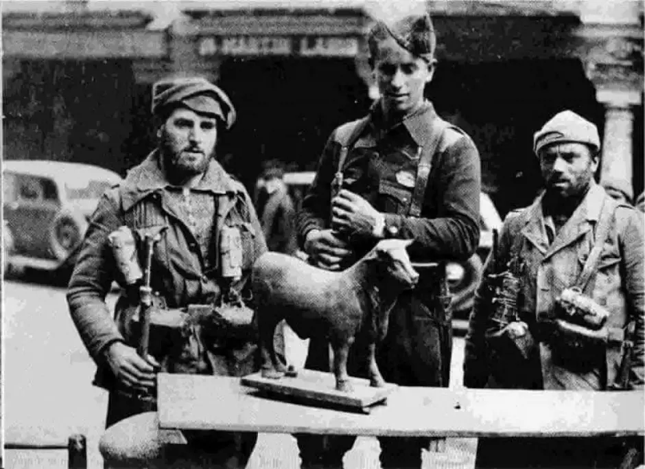 Dos soldados y un joven sargento, en el centro de la imagen, del Ejército de Galicia se fotografían junto al Torico
