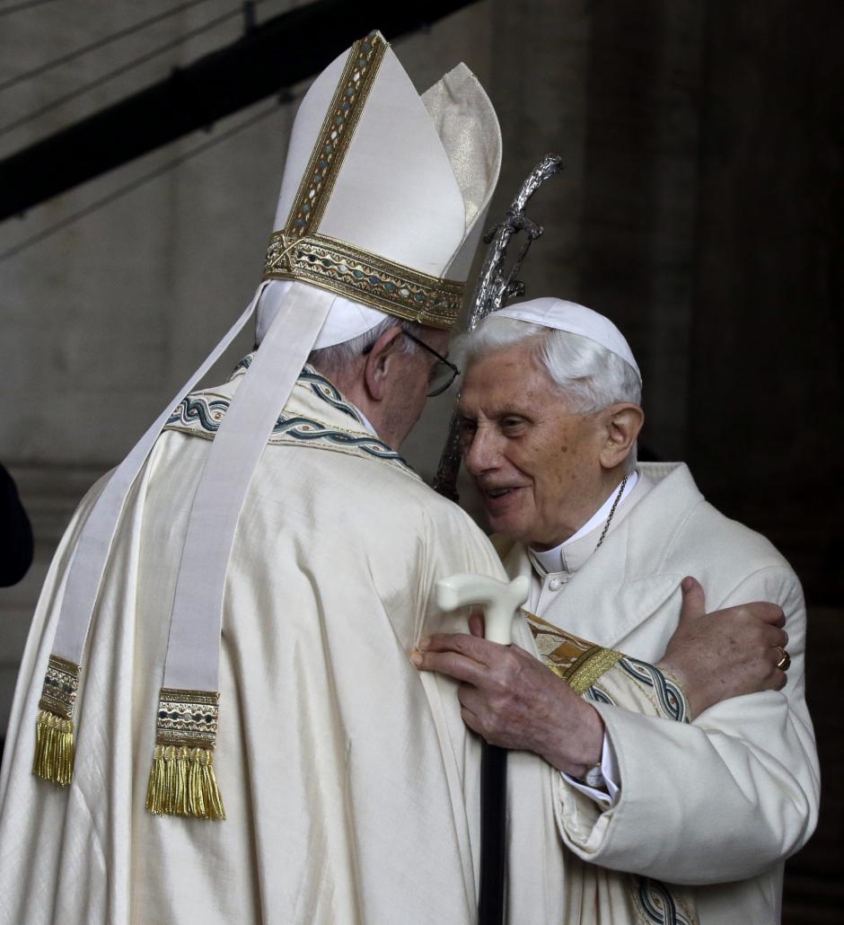 Pope Emeritus Benedict XVI, right, hugs Pope Francis in St. Peter's Basilica during the ceremony marking the start of the Holy Year, at the Vatican, Tuesday, Dec. 8, 2015.