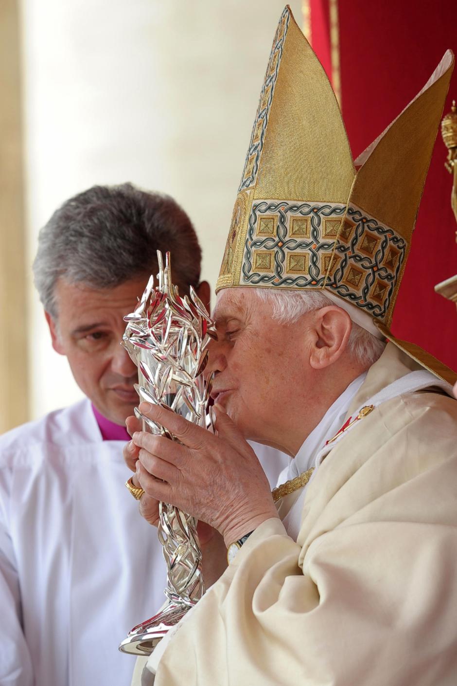Pope Benedict XVI kisses the glass reliquary containing the blood of late Pope John Paul II during his beatification ceremony, in St. Peter's Square, at the Vatican, Sunday, May 1, 2011.