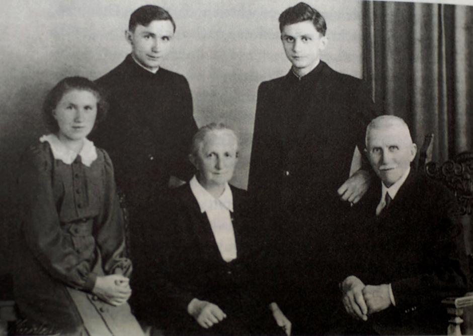In this photo released by the German Catholic News Agency KNA and dated from July, 8, 1951  Joseph Ratzinger, standing right,  is seen with his family, father Joseph, mother Maria and sister Maria, seated from right, and brother Georg following their ordination to the priesthood.