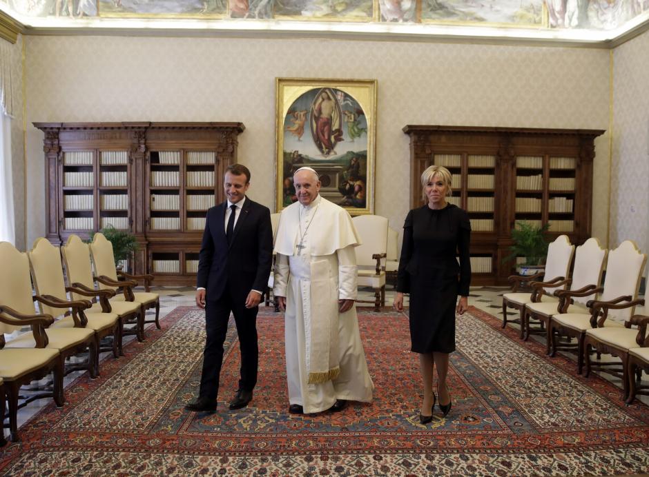 Pope Francis exchanges gifts with French President Emmanuel Macron and his wife Brigitte during a private audience at the Vatican, June 26, 2018.