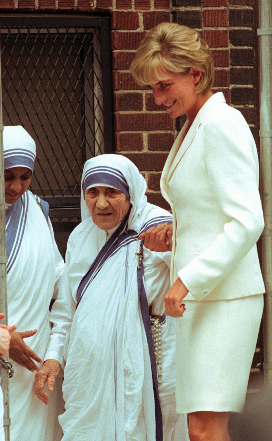 Mother Teresa, left, walks with Princess Diana after receiving a visit from her Wednesday, June 18, 1997, in New York.