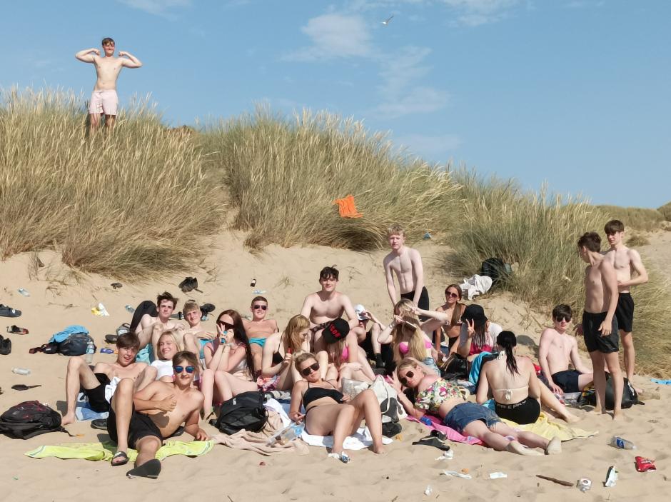Grupos de jóvenes disfrutan del sol en la playa de Formby