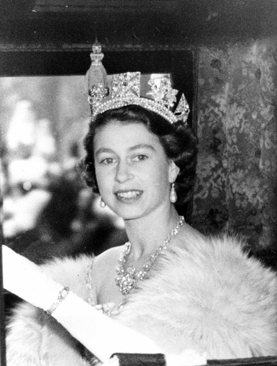 Her Majesty Queen Elizabeth II of England is shown in the state coach as she leaves Buckingham Palace for the Houses of Parliament in London, England, on Nov. 4, 1952.   (AP Photo)