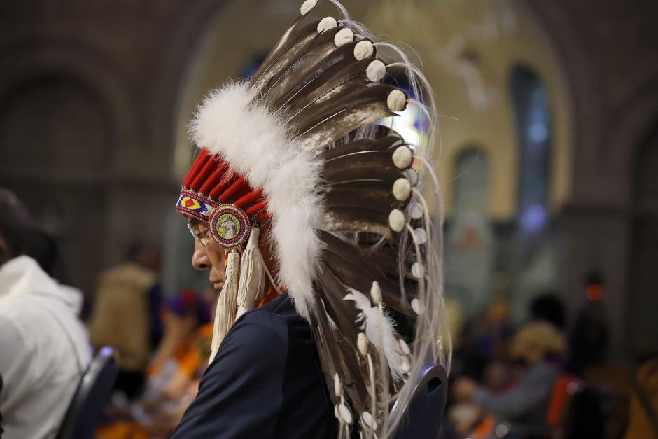 SAINTE-ANNE-DE-BEAUPRE, CANADA - JULY 28: Indigenous people bow their heads in prayer as Pope Francis celebrates mass at the National Shrine of Sainte-Anne-de-Beaupre on July 28, 2022 in Sainte-Anne-de-Beaupre, Canada. Pope Francis is traveling across Canada on a pilgrimage of penance, meeting with and apologizing to Indigenous communities for the abuse at Catholic-run residential schools, where more than 150,000 indigenous children were forcibly enrolled for more than 100 years. Called a cultural genocide by the Canadian Truth and Reconciliation Commission, the school system was created to isolate Indigenous children from their own native culture and religion in order to assimilate them into the dominant Christian culture.   Chip Somodevilla/Getty Images/AFP (Photo by CHIP SOMODEVILLA / GETTY IMAGES NORTH AMERICA / Getty Images via AFP)