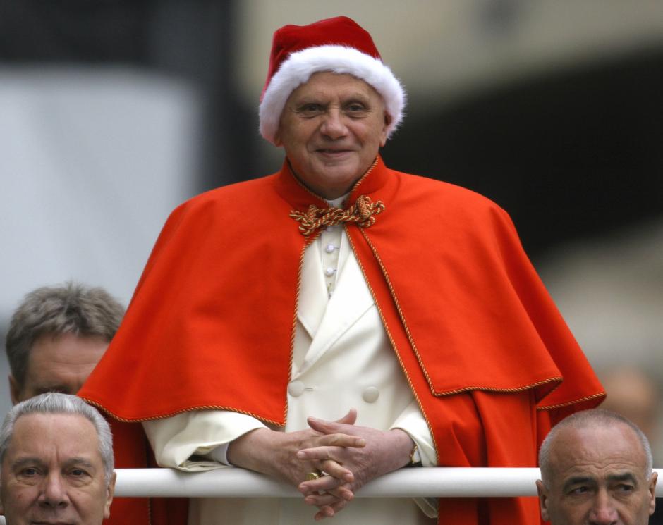 Pope Benedict XVI, sporting a fur-trimmed hat in the rich red color of a Santa hat , arrives in St. Peter's Square at the Vatican, Wednesday, Dec. 21, 2005 for his weekly general audience. The red hat with white fur trimming is known in Italian as the "camauro." It was popular among pontiffs in the 17th century. More recently, it was used by Pope John XXIII, who was also buried with it in 1963. (AP Photo/Alessandra Tarantino)