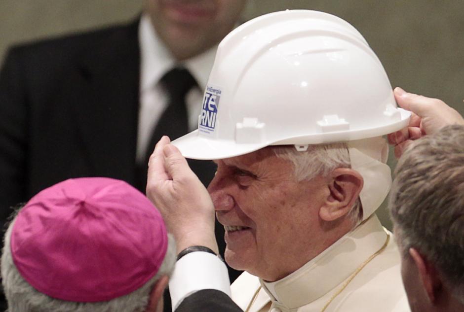 Pope Benedict XVI tries on a metal worker's protective helmet during a special audience at the Vatican, Saturday, March 26, 2011.