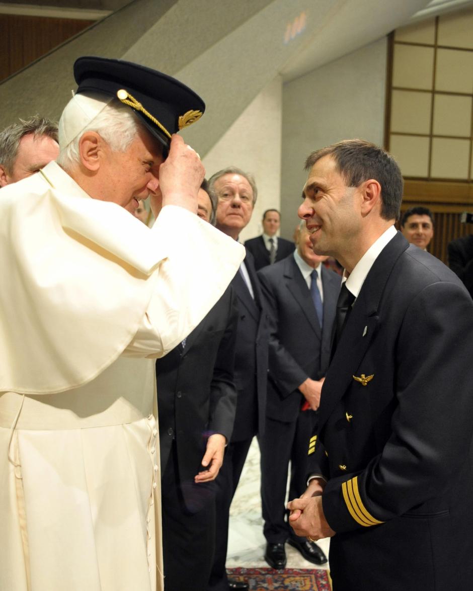 In this photo provided by the Vatican newspaper L'Osservatore Romano, Pope Benedict XVI, tries a pilot's hat during a special audience with Italy's Civil Aviation Authority ENAC (Ente Nazionale per l'Aviazione Civile) personnel, in the Paul VI hall, at the Vatican, Saturday, Feb. 20, 2010. Looking on at center is Italy's Transport and Infrastructure Minister Altero Matteoli