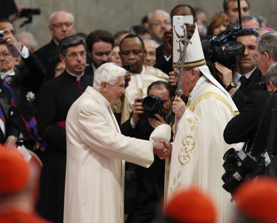 Pope Francis salutes Pope Emeritus Benedict XVI, left, at the end of a consistory inside the St. Peter's Basilica at the Vatican, Saturday, Feb.22, 2014.