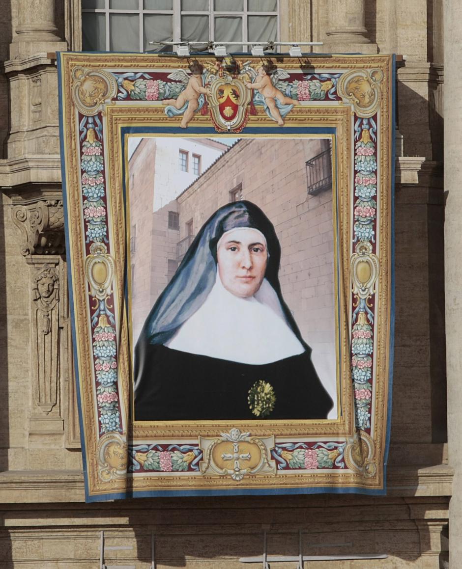 The tapestry of Saint Candida Maria de Jesus Cipitria y Barriola, of Spain, is displayed on the on the facade of St. Peter's Basilica during a Canonization Mass celebrated in St. Peter's square at the Vatican, Sunday, Oct. 17,  2010.