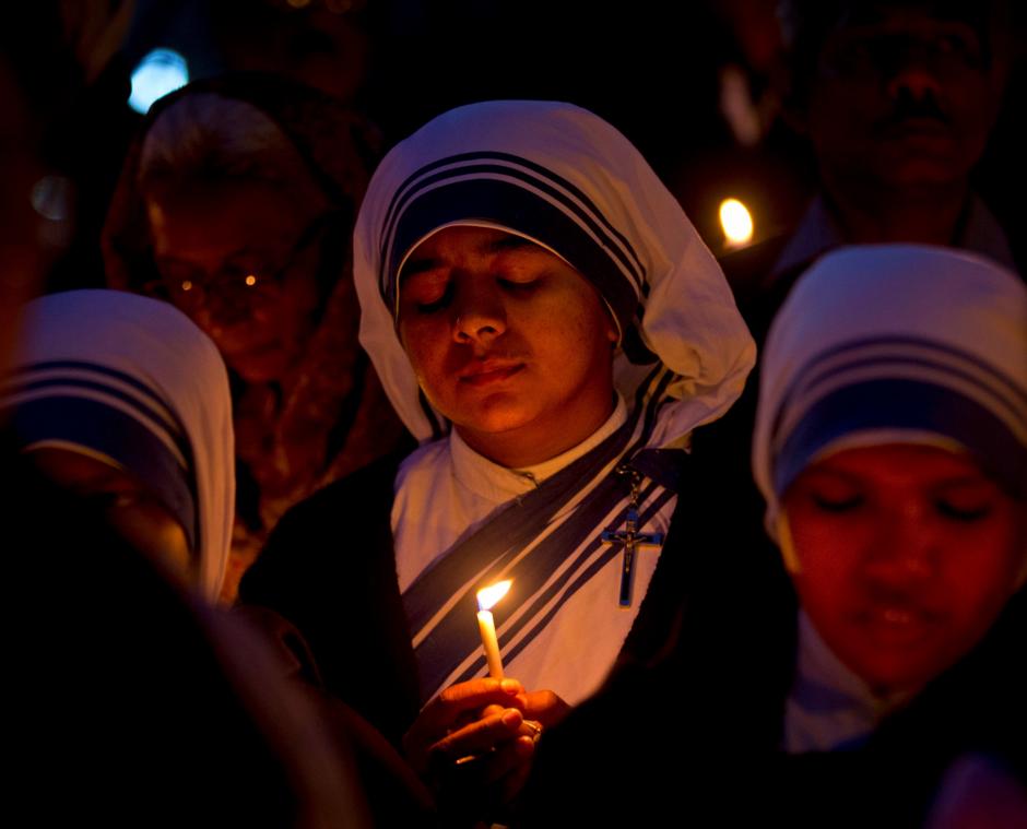 Christian nuns pray as they hold a candle light vigil to condemn the gang rape of a nun at a Christian missionary school in eastern India in New Delhi, India, Monday, March 16, 2015.