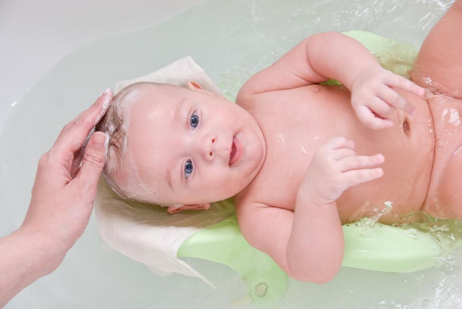 mother washing her son at bathing stand