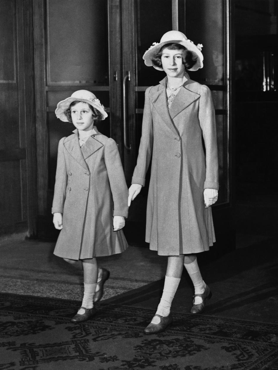 Princess Margaret Rose, left, and Princess Elizabeth arrived at Olympia for a performance of the International Horse Show, June 21, 1939, London, England. 
British Royalty,Children,Coat,Elizabeth II of the United Kingdom,Full Length,Hat,Her Majesty,HM The Queen,Monarchy,Royal Family,Smile