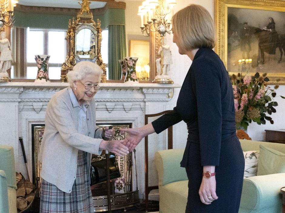 Britain's Queen Elizabeth II, left, welcomes Liz Truss during an audience at Balmoral, Scotland, where she invited the newly elected leader of the Conservative party to become Prime Minister and form a new government, Tuesday, Sept. 6, 2022.