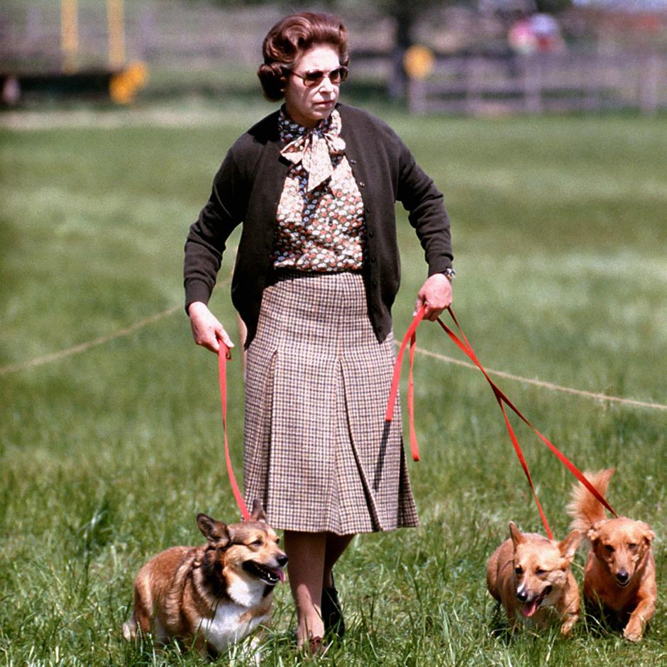 File photo dated 17/05/80 of Queen Elizabeth II with some of her corgis walking
