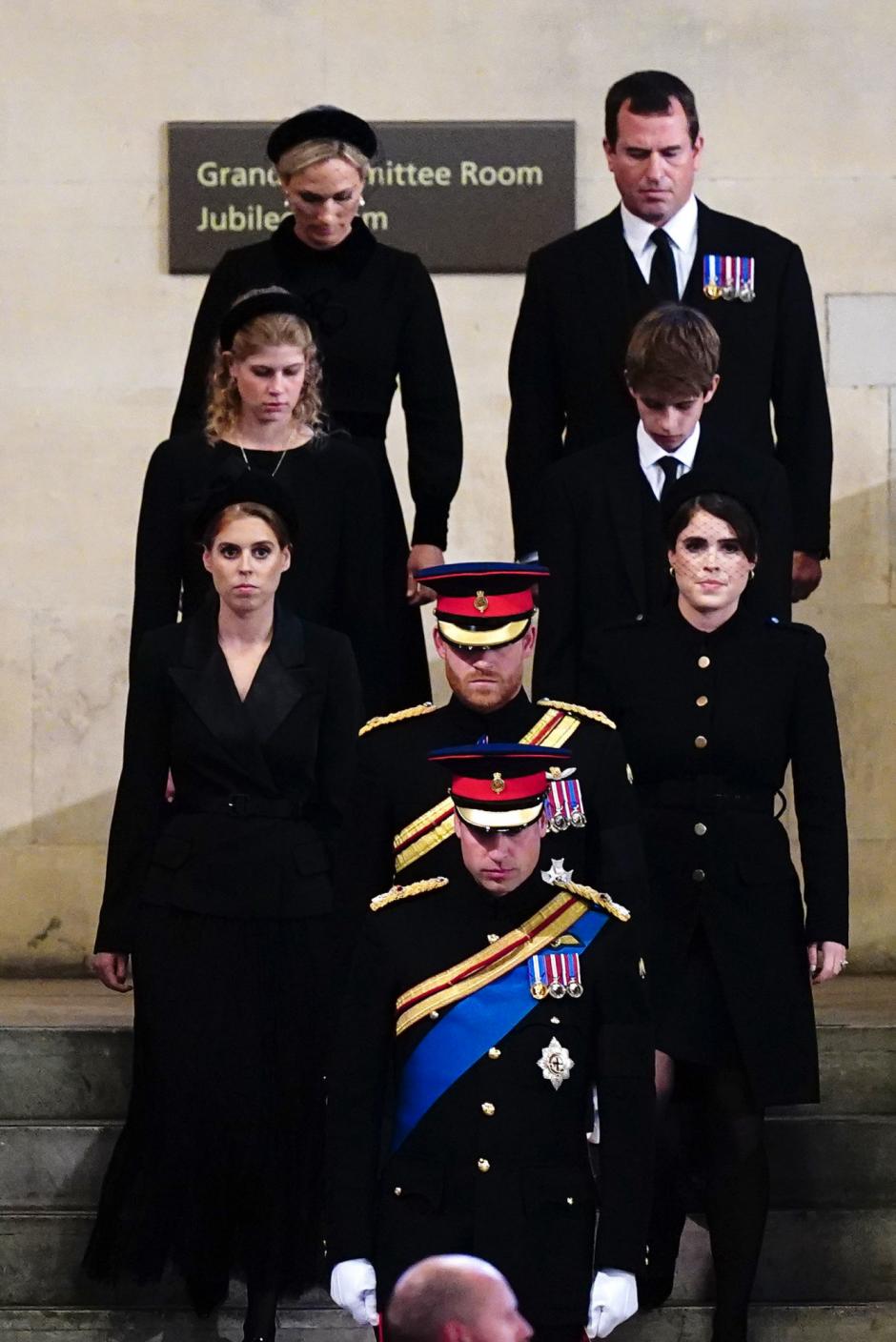 Queen Elizabeth II 's grandchildren (L-R) Britain's Prince William, Prince of Wales, Peter Phillips,  Zara Tindall, James, Viscount Severn, Britain's Princess Eugenie of York, Britain's Lady Louise Windsor, Britain's Princess Beatrice of York and Britain's Prince Harry, Duke of Sussex, depart having held a vigil around the coffin of Queen Elizabeth II, draped in the Royal Standard with the Imperial State Crown and the Sovereign's orb and sceptre, lying in state on the catafalque in Westminster Hall, at the Palace of Westminster in London on September 17, 2022, ahead of her funeral on Monday. - Queen Elizabeth II will lie in state in Westminster Hall inside the Palace of Westminster, until 0530 GMT on September 19, a few hours before her funeral, with huge queues expected to file past her coffin to pay their respects. (Photo by Chris Jackson / POOL / AFP)
