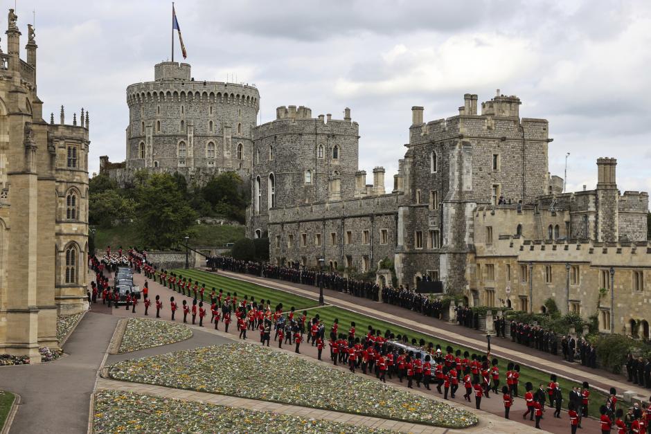 The Royal Family and Grenadier Guards escort the coffin to St. George's Chapel at Windsor Castle, Windsor, England, Monday Sept. 19, 2022, ahead of the committal service for Queen Elizabeth II. The Queen, who died aged 96 on Sept. 8, will be buried at Windsor alongside her late husband, Prince Philip, who died last year. (Adrian Dennis/Pool via AP)