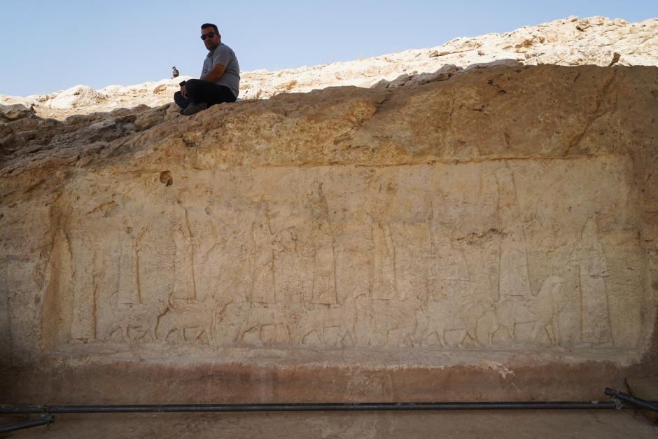 A picture shows a carved plaque lining an ancient irrigation canal dating back to Assyrian times, in the archaeological site of Faydeh (Faida) in the mountains near the town of the same name in the autonomous Kurdish region of Iraq, on October 16, 2022, during the opening of the first phase of a planned archaeological park in Iraqi Kurdistan. (Photo by Ismael ADNAN / AFP)